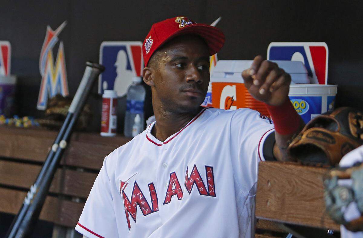 Miami Marlins center fielder Lewis Brinson looks from the dugout before the start of a Major League Baseball game against the Tampa Bay Rays at Marlins Park on Tuesday, July 3, 2018. The Rays beat Marlins 9-6 in 16th innings.