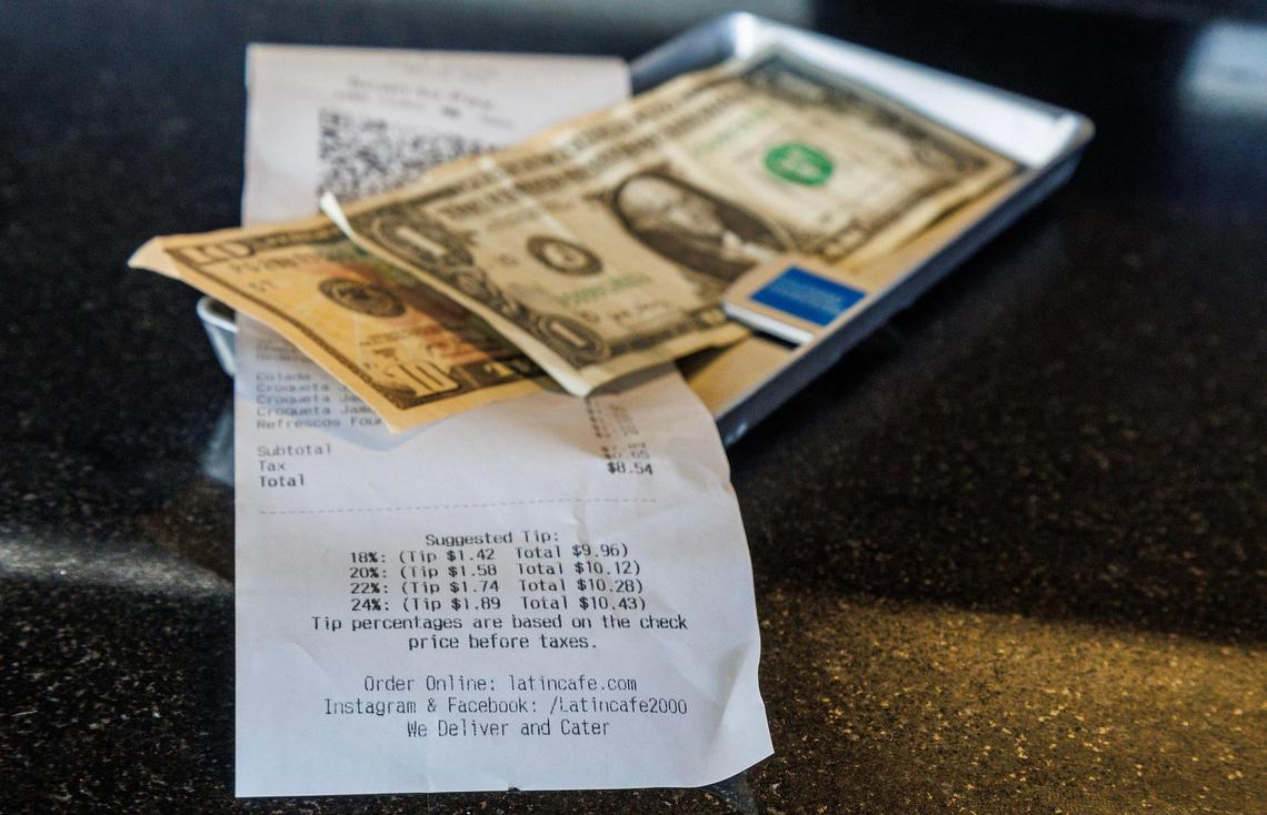 View of a bill that includes tip suggestions ready to be paid at the Latin Cafe 2000.