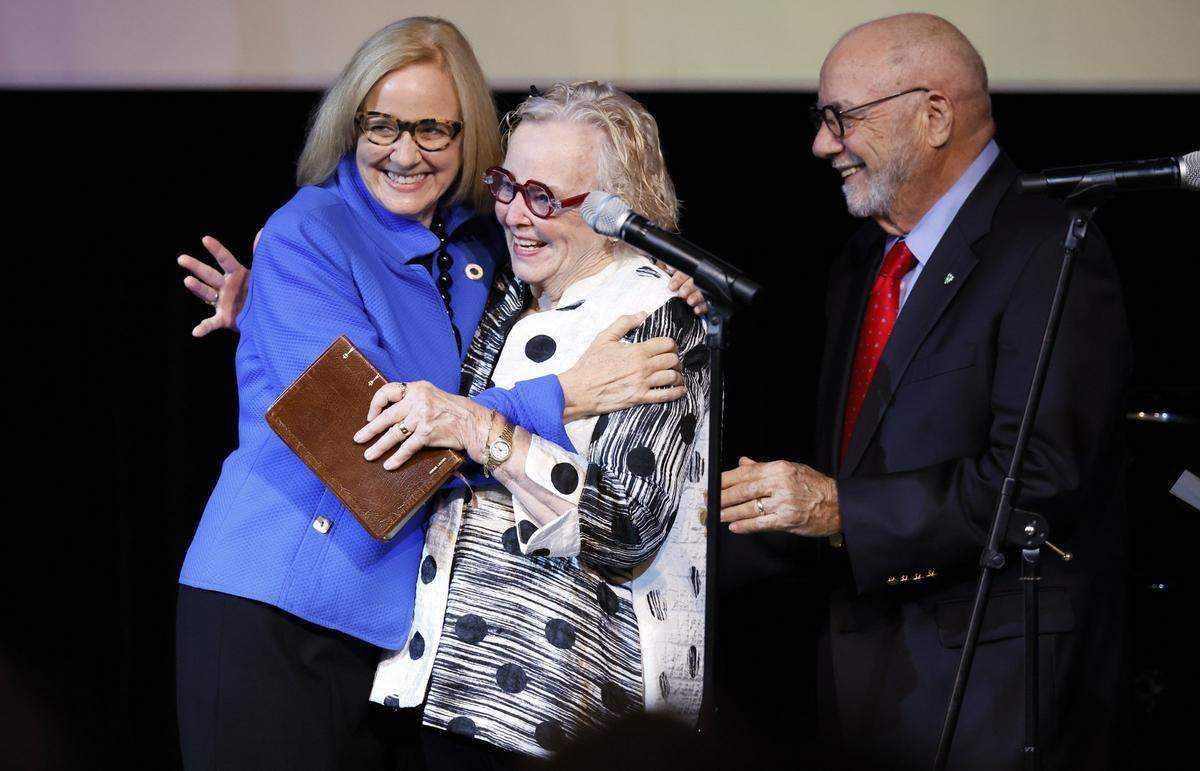 Cornelius and Patricia Higgins on stage with their daughter Eileen Higgins during the installation ceremony as the Mayor of the City of Miami at the Miami-Dade College Wolfson Campus Auditorium in Miami, Florida, on Thursday, December 18, 2025. 