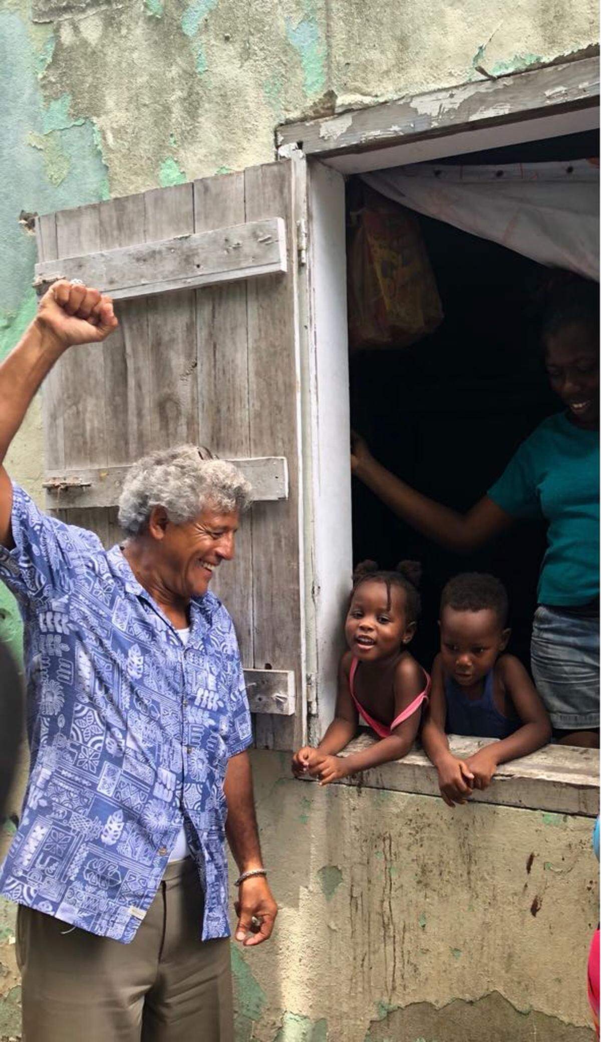 Bahamas human rights attorney Fred Smith visits children of Haitian immigrants in the Bahamas. Smith, a defender of the community, has been the target of protests and attacks over the years.