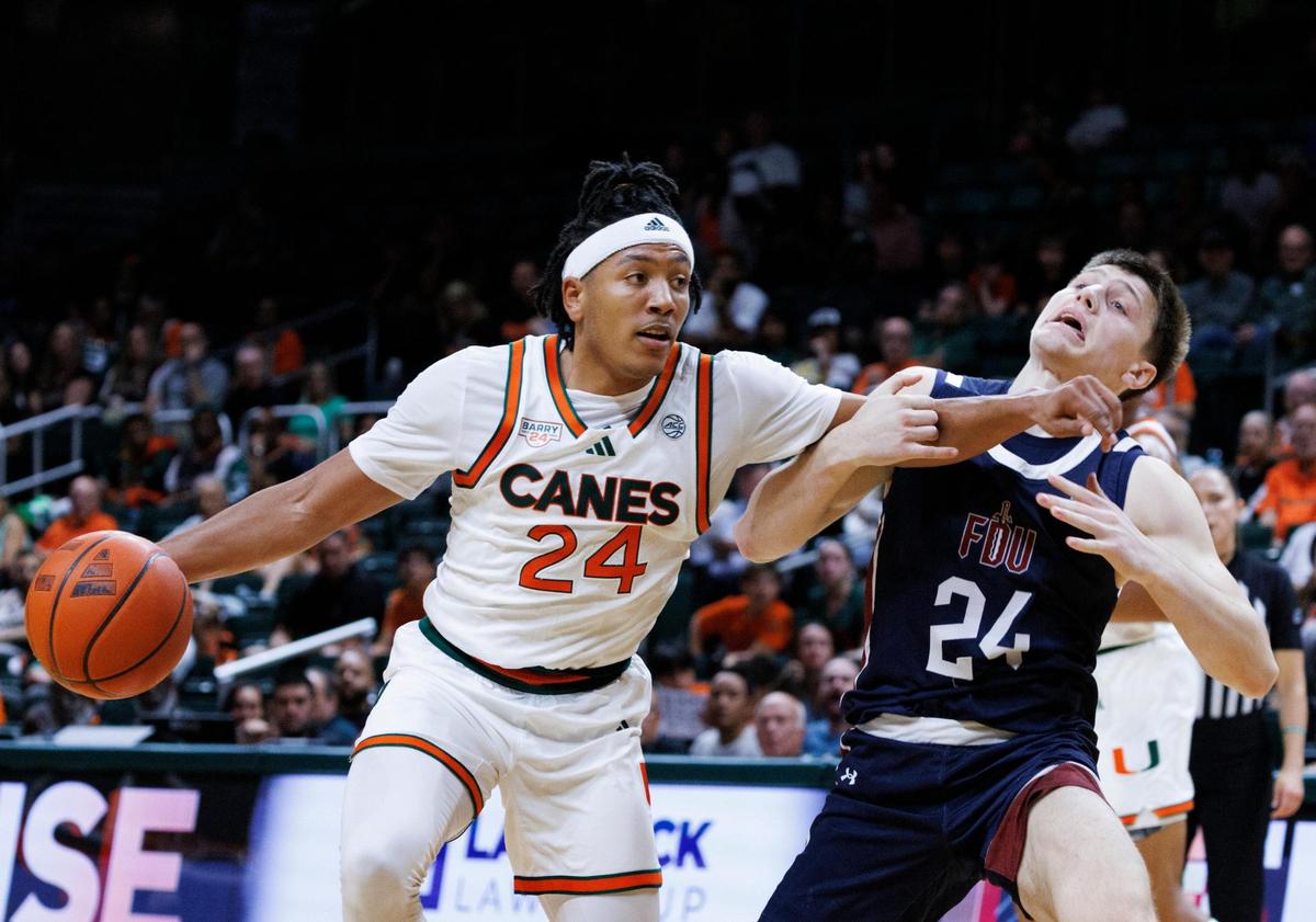 Miami Hurricanes Nijel Pack (24) dribbles around Fairleigh Dickinson Knights Brayden Reynolds (24) during the first half of the season opener game on Monday, Nov. 4, 2024, at Watsco Center in Coral Gables, Fla.