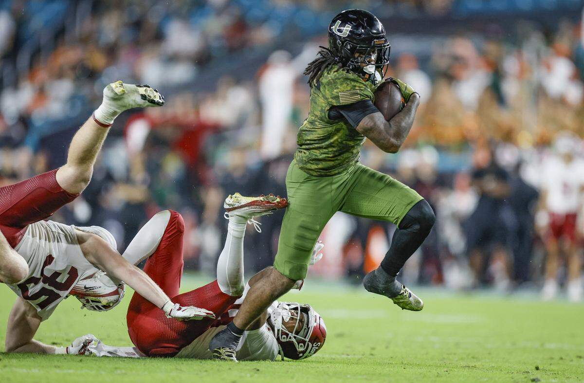 Miami Hurricanes running back Mark Fletcher Jr. (4) on a carry in the first half against the Stanford Cardinal during their NCAA football game at Hard Rock Stadium in Miami Gardens, Florida, on Saturday, October 25, 2025.