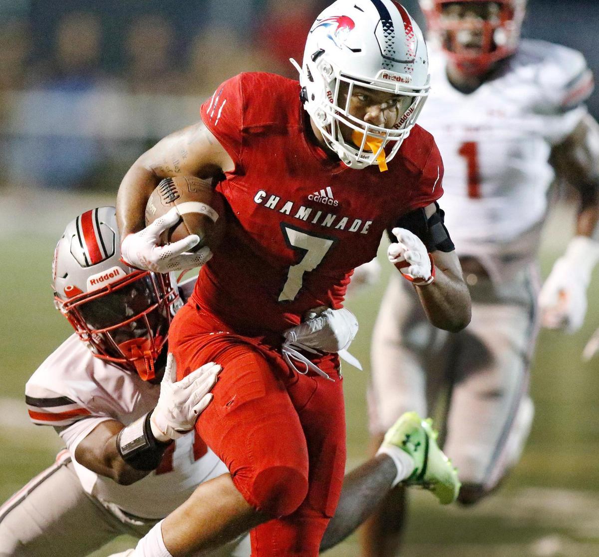 Chaminade Madonna Lions running back Davion Gause (7) carries the ball against St. John’s College Prep Eagles during football game on Saturday, August 27, 2022 at St. Thomas Aquinas HS in Fort Lauderdale. Andrew Uloza / for Miami Herald