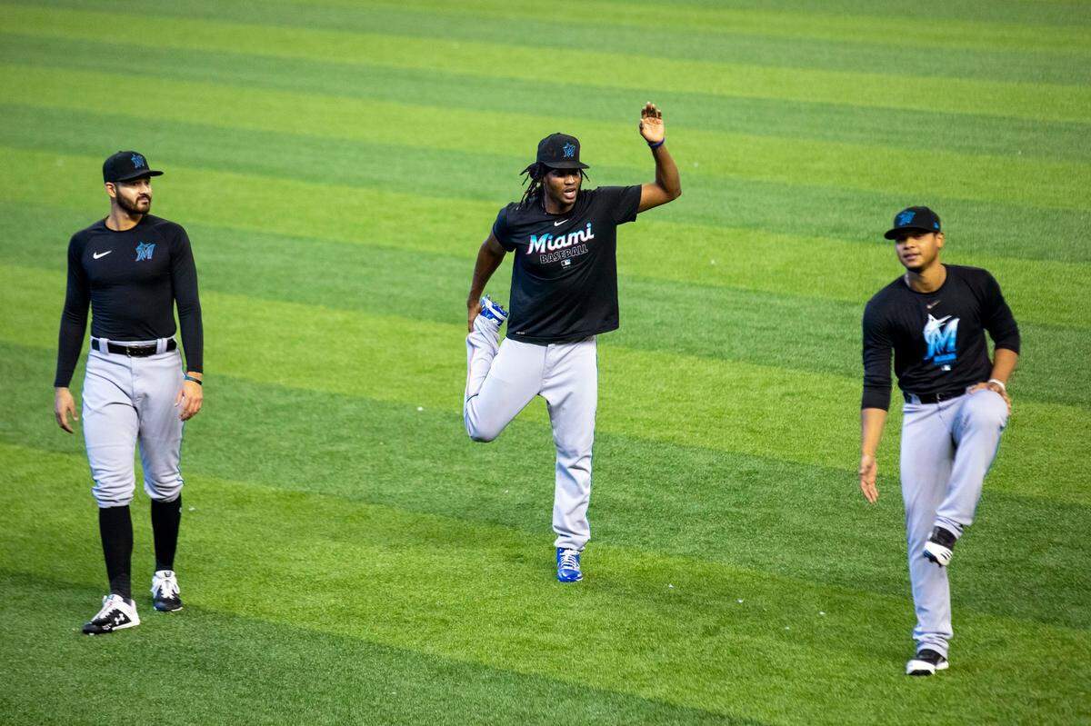 Marlins pitchers Pablo Lopez, Jose Urena, and Elieser Hernandez warm up together during practice at Marlins Park in Miami, Florida on Monday, July 20, 2020.