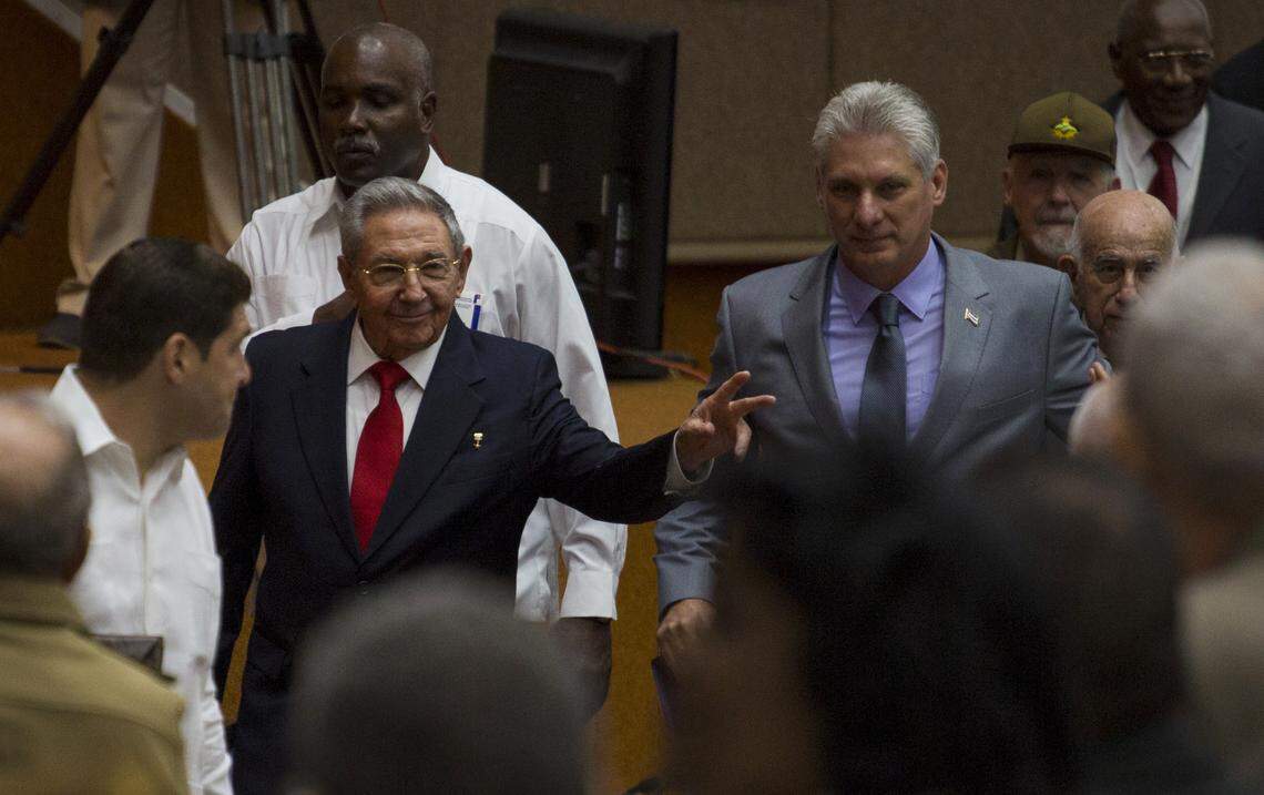 In this photo released by Cuba's state-run media Cubadebate, Cuba's President Raúl Castro, center left, enters the National Assembly followed by his successor, Miguel Díaz-Canel, center right, for the start of two-day legislative session in Havana.