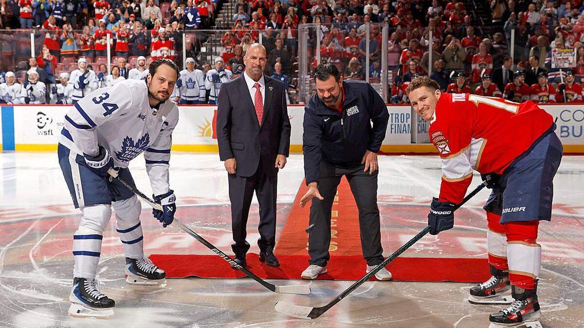 SUNRISE, FLORIDA - FEBRUARY 26: Florida Panthers President and General Manager Bill Zito and Team USA Equipment Manager Teddy Richards drop the ceremonial puck to Matthew Tkachuk #19 of the Florida Panthers and Auston Matthews #34 of the Toronto Maple Leafs at the Amerant Bank Arena on February 26, 2026 in Sunrise, Florida. (Photo by Eliot J. Schechter/NHLI via Getty Images)