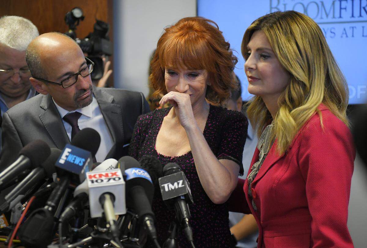 Kathy Griffin, center, sobs as she speaks along with her then-attorneys Dmitry Gorin, left, and Lisa Bloom during a June 2017 news conference  in Los Angeles, a few days after a photo went viral of Griffin holding a likeness of President Donald Trump’s severed head.