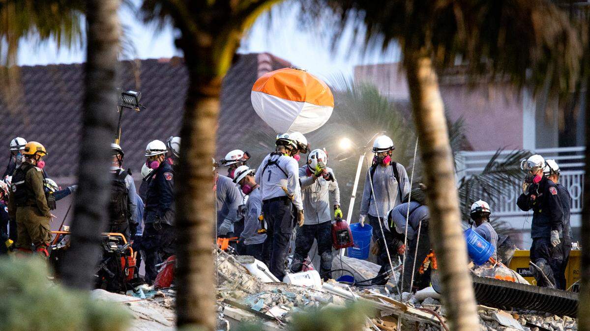 Search and rescue personnel search for survivors through the rubble at the Champlain Towers South Condo in Surfside, Florida, Wednesday, June 30, 2021. The apartment building partially collapsed on Thursday, June 24.