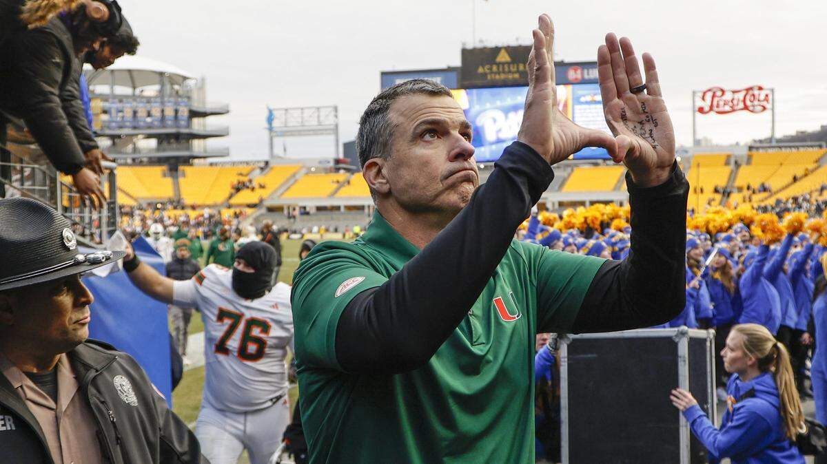 Miami Hurricanes head coach Mario Cristobal flashes the U after the Canes defeat the Pittsburgh Panthers 38-7 during their NCAA football game at Acrisure Stadium in Pittsburgh, PA, on Saturday, November 29, 2025. 