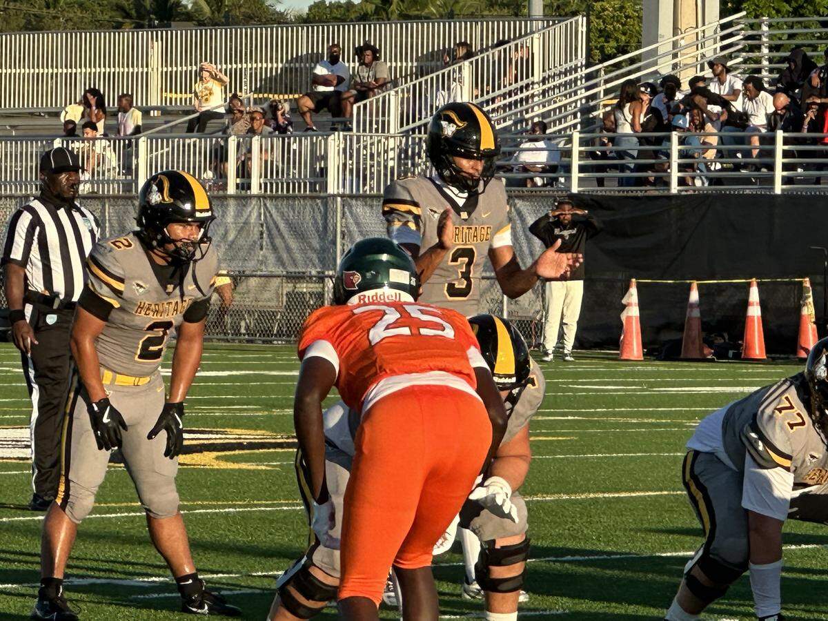 American Heritage quarterback Dia Bell readies to take a snap during Friday’s 23-14 win over Hollywood McArthur in an exhibition game at American Heritage School in Plantation.