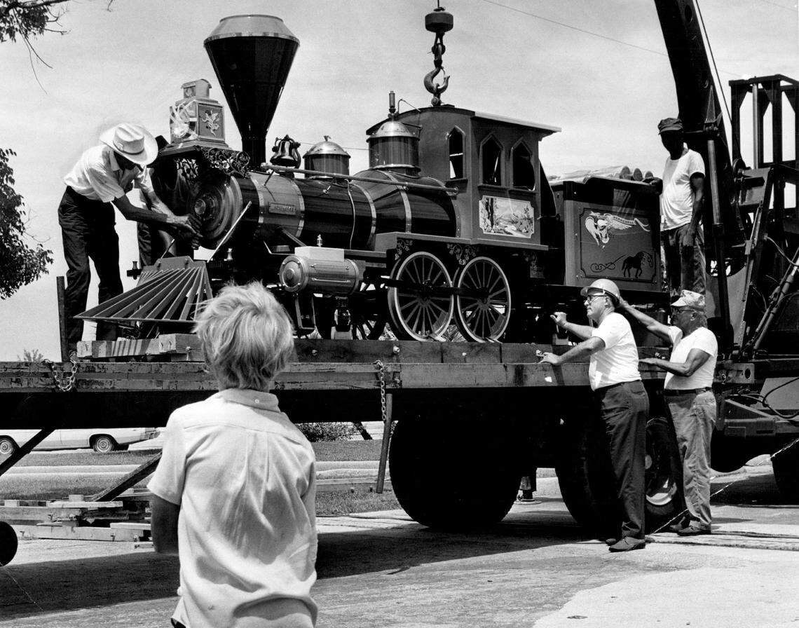A new train engine for Crandon Park Zoo is unloaded from a truck. The engine is a replica of an old “iron horse.”