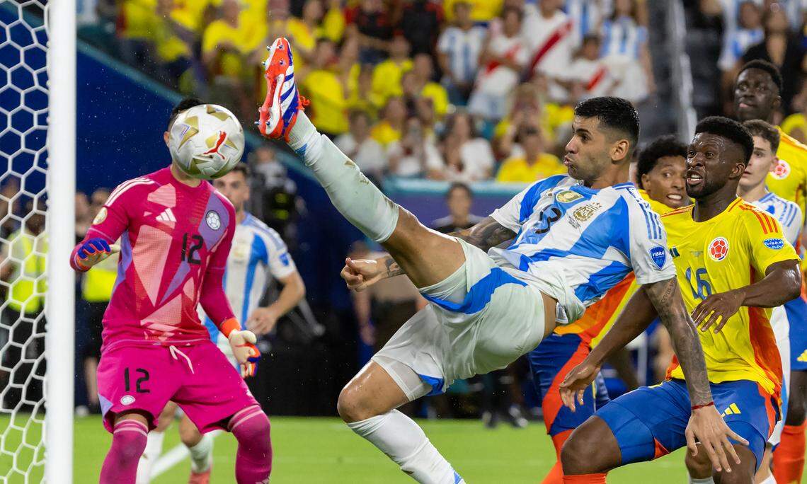 Argentina defender Cristian Romero (13) tries to scores a goal against Colombia goalkeeper Camilo Vargas (12) and midfielder Jefferson Lerma (16) in the second half of the Copa America 2024 Final soccer match at Hard Rock Stadium on Sunday, July 14, 2024, in Miami Gardens, Fla.
