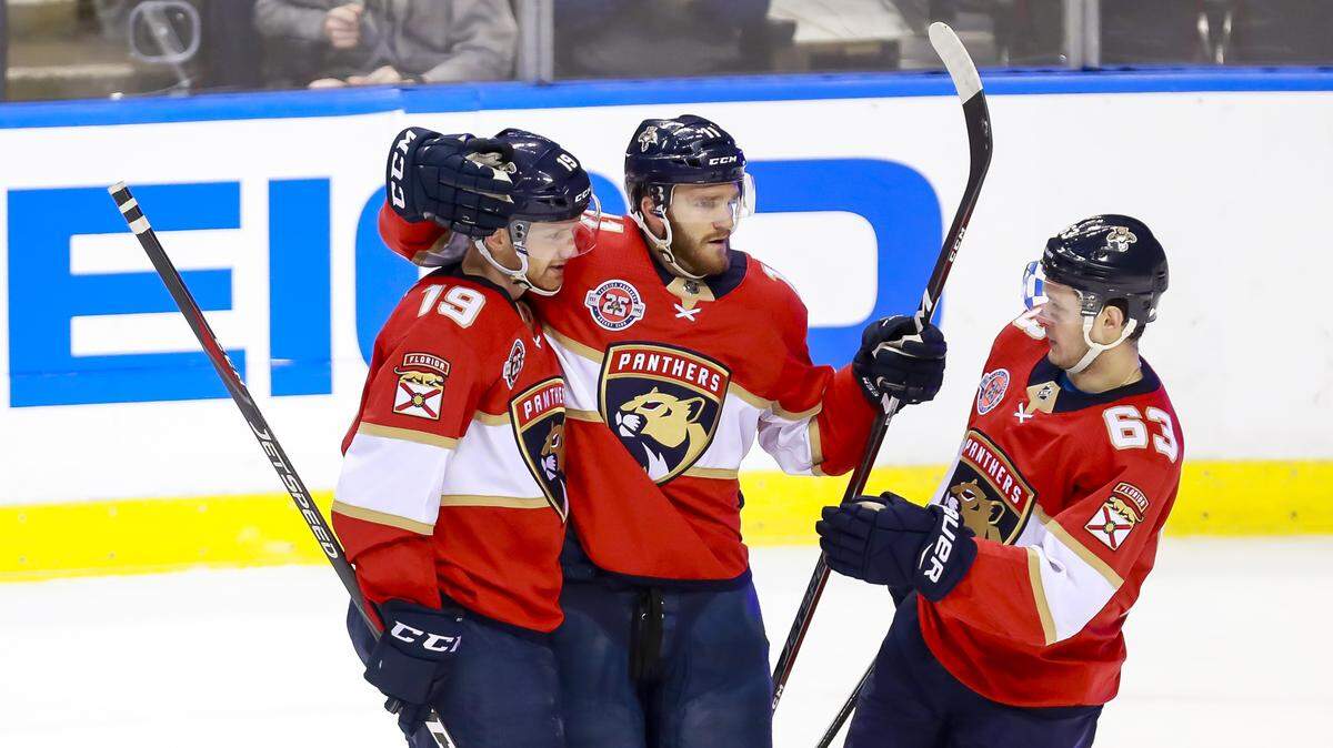 Florida Panthers defense Mike Matheson (19) celebrates with this teammates after scoring against the Minnesota Wild in the second period of a hockey game at the BB&T Center in Sunrise, Florida on Friday, March 8, 2019.