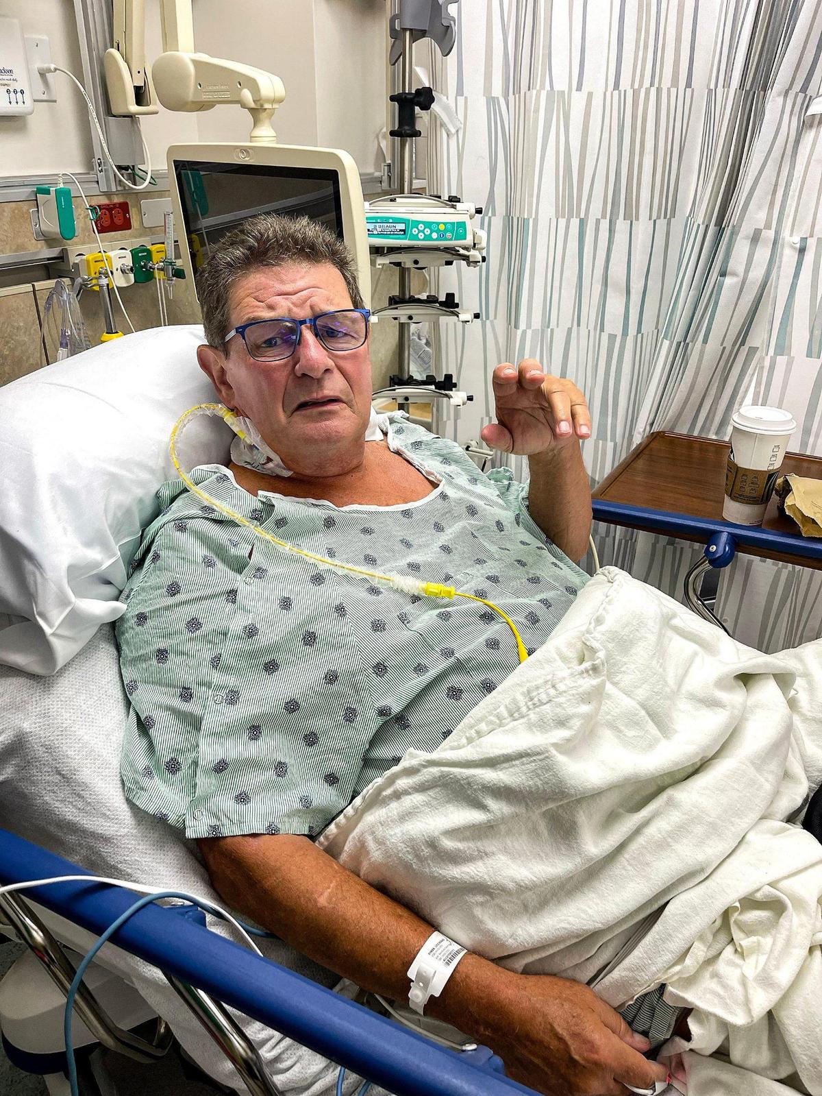 Lyle Ryman, 70, sits up in bed at Jackson Memorial Hospital on Thursday, April 27, 2023. He had gone to the Miami Transplant Institute at Jackson three times over the past three years, thinking he would get a heart transplant but complications ensued. With the adult heart transplant suspended at the institute, he is weighing his options.