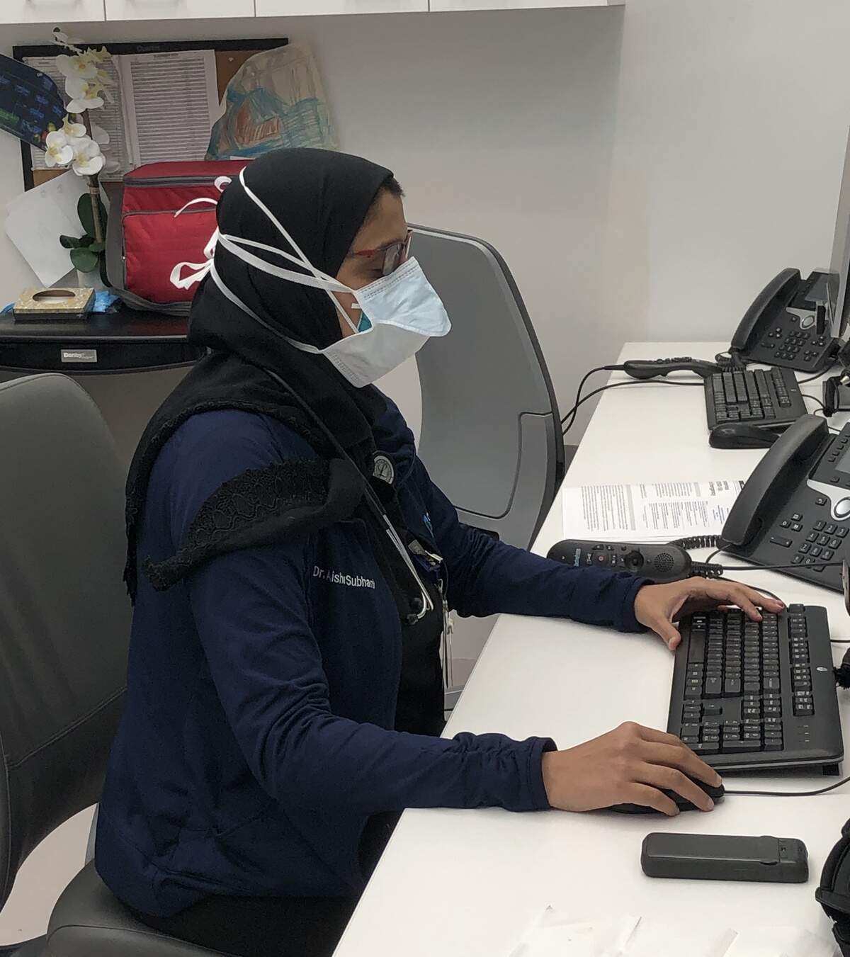 Dr. Aisha Subhani, an emergency medicine physician in South Florida, works at her computer at the Cleveland Clinic Florida in Weston on Thursday, April 23, 2020. A practicing Muslim, Subhani prays that Ramadan will help alleviate the somber mood brought by the novel coronavirus.