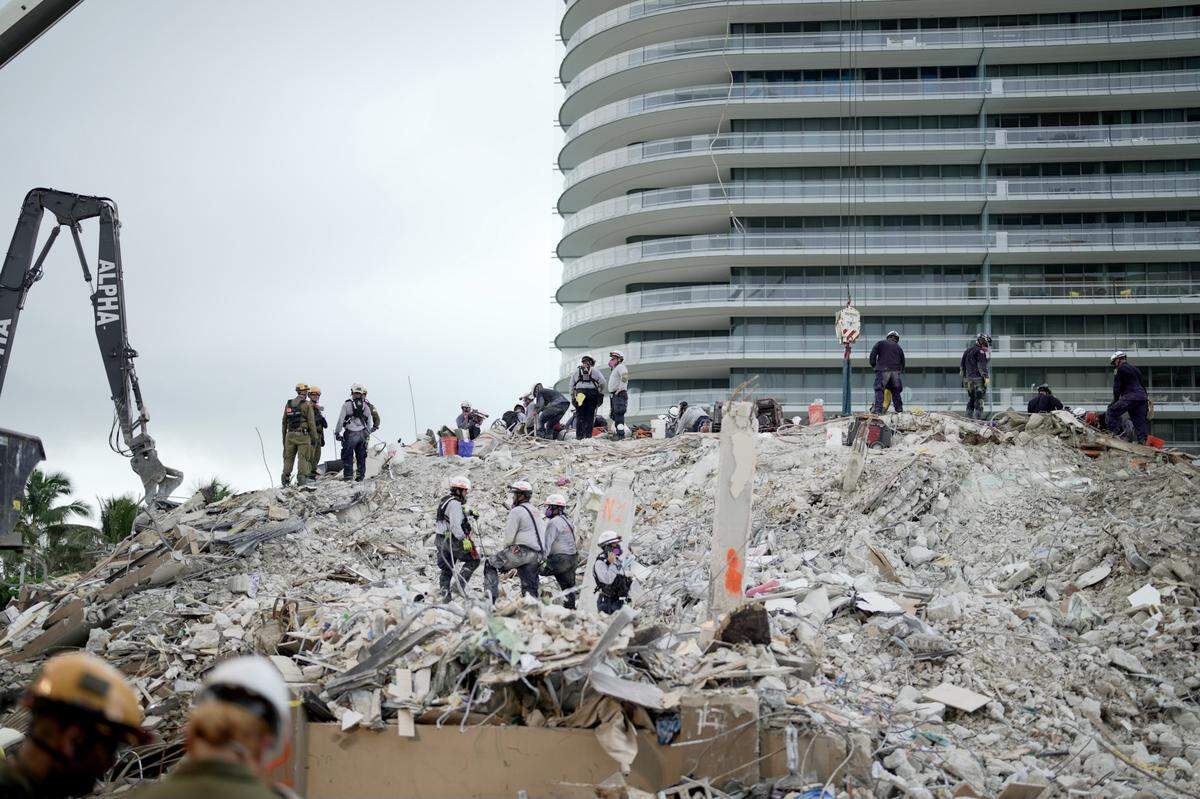 Eighty Seven Park luxury condo building on June 30, behind the rubble that used to be Champlain Towers South.