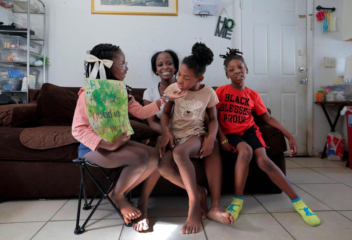 At their Miami home are Willnat Young, a single mom of three children, Aaliyah Matin and twins Amaziah Young and Ammiel Young. The twins were born premature and are autistic and contend with developmental and medical problems.