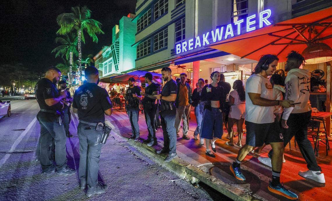 Police officers patrol Ocean Drive on Friday, March 20, 2026.