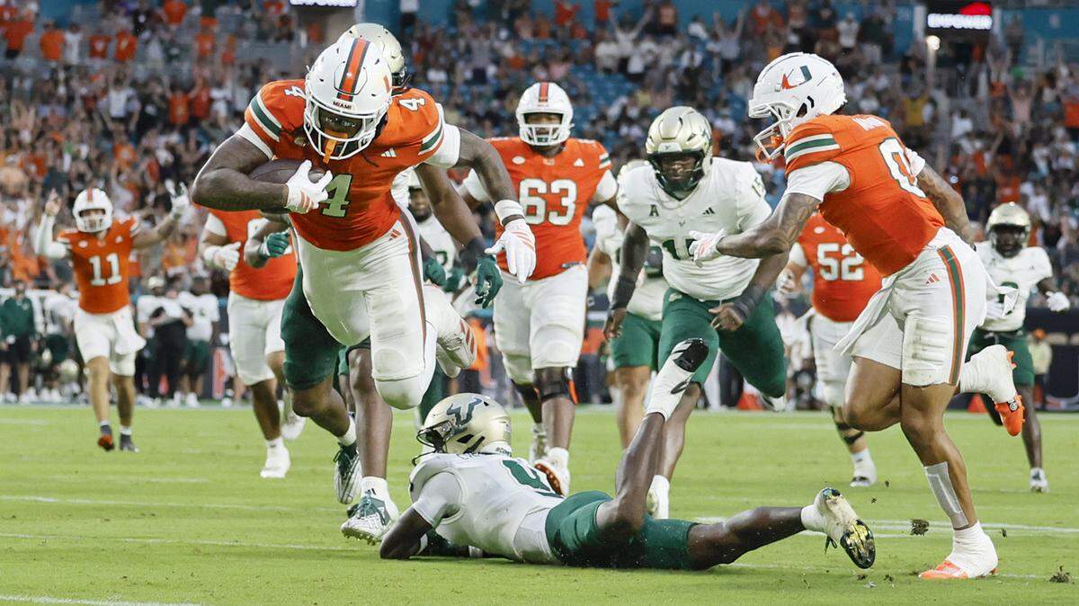 Miami Hurricanes running back Mark Fletcher Jr. (4) scores in the first half of their NCAA football game against the South Florida Bulls at Hard Rock Stadium in Miami Gardens, Florida, on Saturday, September 13, 2025.