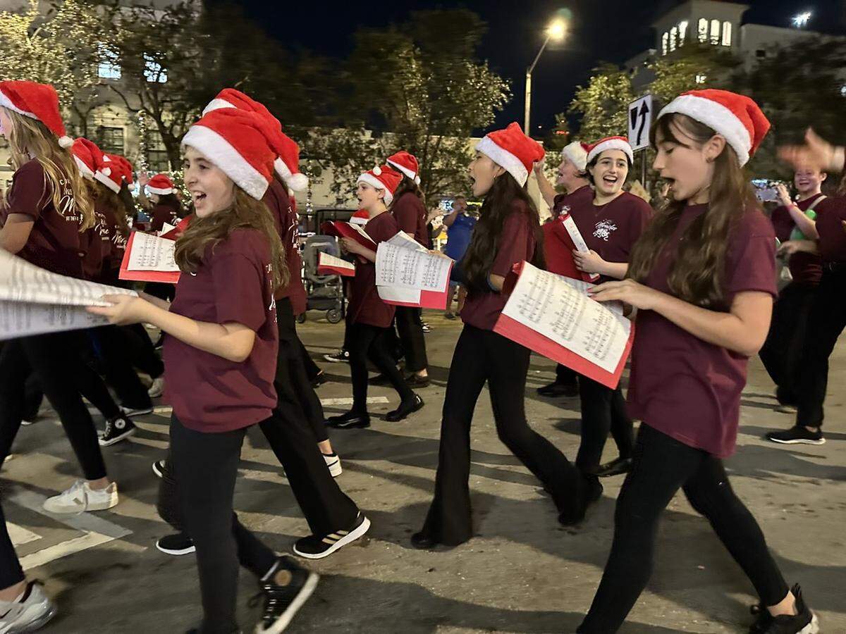 The Miracle Theatre is also celebrating its 75th anniversary alongside Junior Orange Bowl. Here, members of the theater’s Actors’ Playhouse Musical Miracles march in the parade on Miracle Mile just outside the theater’s marquee on Dec. 10, 2023, in Coral Gables.