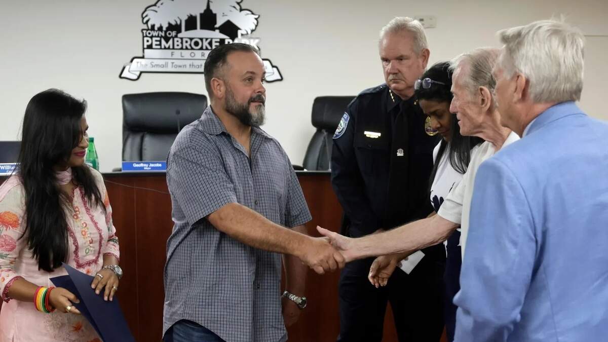 Former Broward Sheriff’s deputy Maury Hernandez is congratulated after he was recognized with a resolution by the Town of Pembroke Park on Wednesday. Hernandez was shot in the head nearly 20 years ago while trying to conduct a routine traffic stop while working as a deputy assigned to the city.