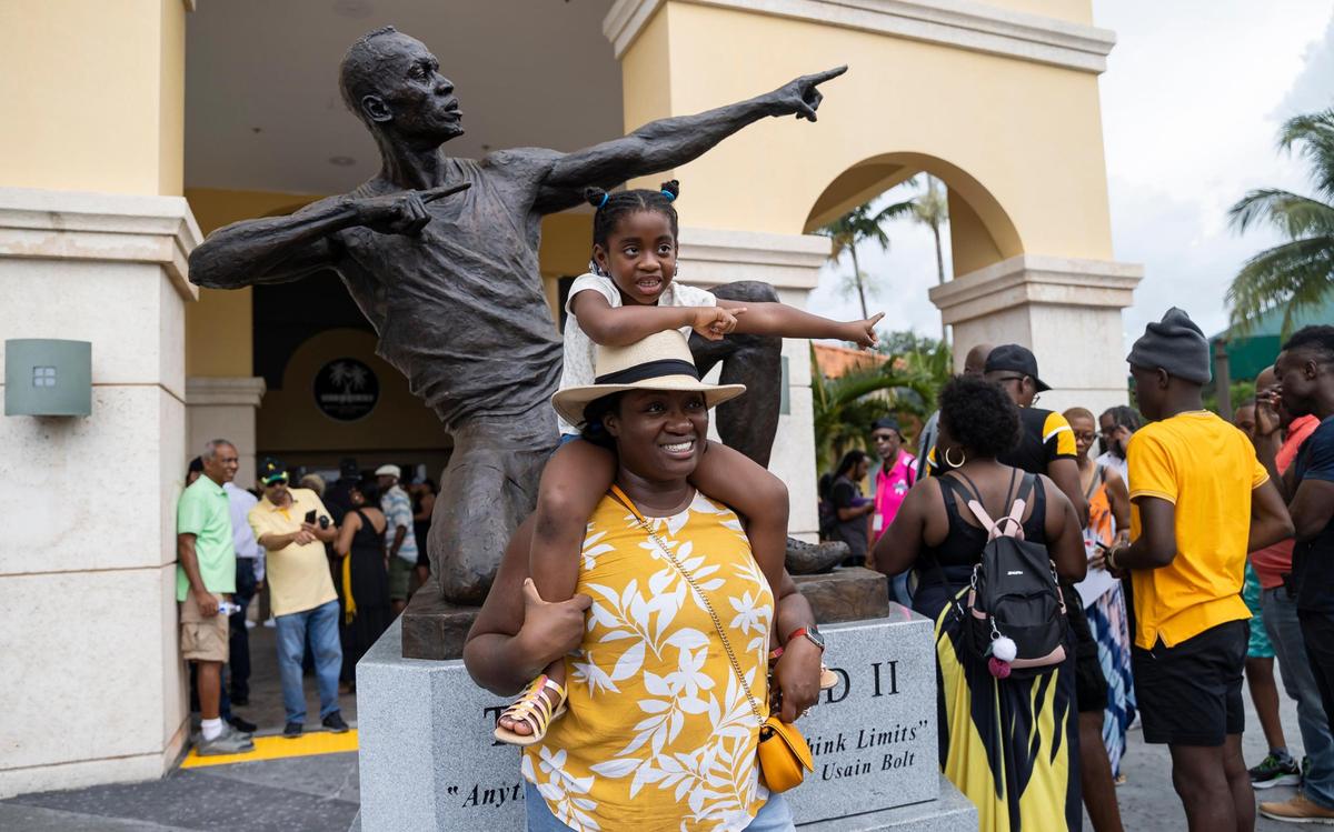 Kaydene Green and her daughter, Amelia Green, 6, are photographed in front of the newly unveiled bronze sculpture of Olympic gold medalist Usain Bolt at the Ansin Sports Complex on Saturday, July 15, 2023, in Miramar, Fla.