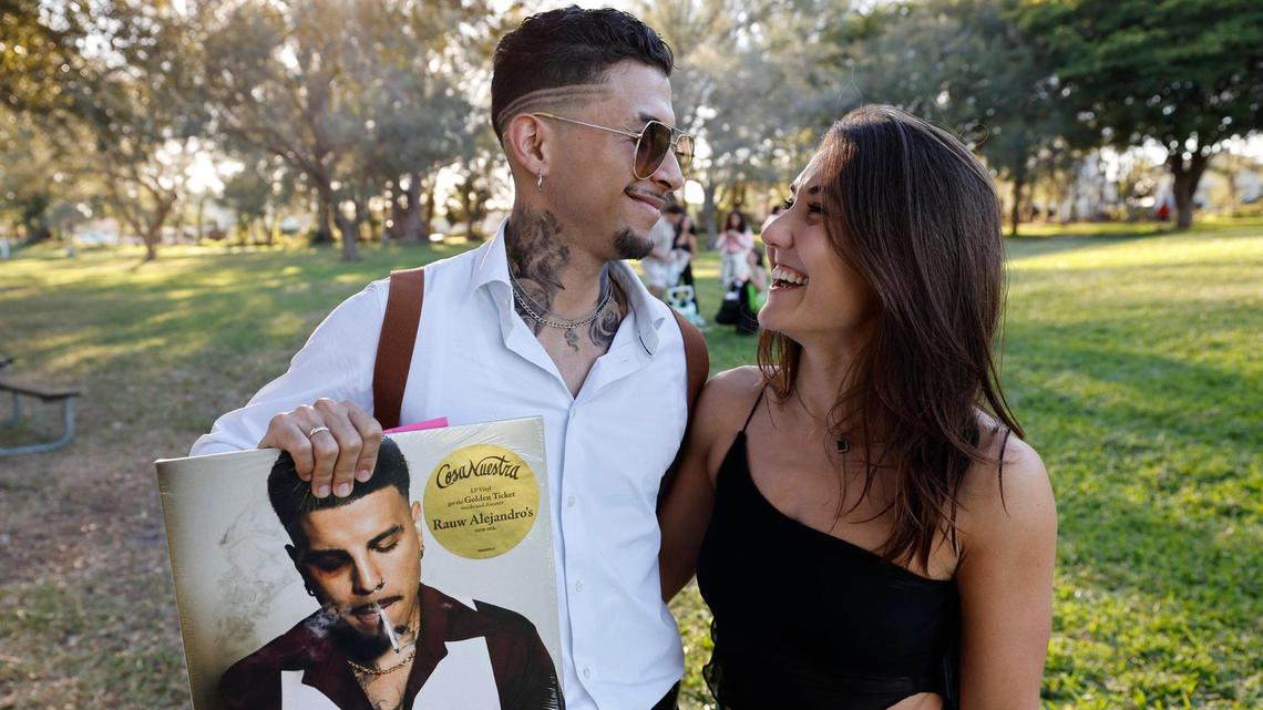 Alejandro Restrepo, 25, of Miami is embraced by a woman who only gave her name as Jenna, 30, of Miami. Restrepo won the Rauw Alejandro look-alike contest at Tropical Park in Miami, Florida, on Friday, November 22, 2024.