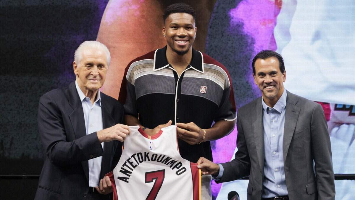Giannis Antetokounmpo poses with Pat Riley and Erik Spoelstra
