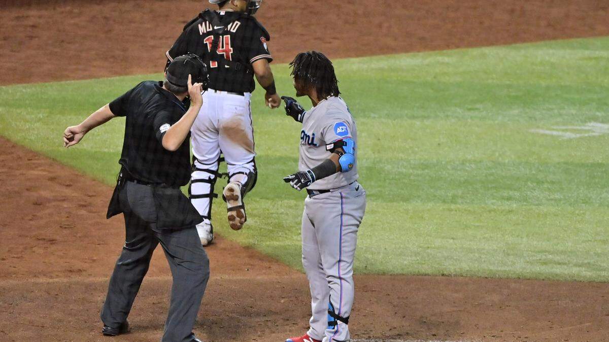 May 8, 2023; Phoenix, Arizona, USA; Miami Marlins third baseman Jean Segura (9) is ejected by umpire Mark Ripperger (90) in the sixth inning against the Arizona Diamondbacks at Chase Field. Mandatory Credit: Matt Kartozian-USA TODAY Sports