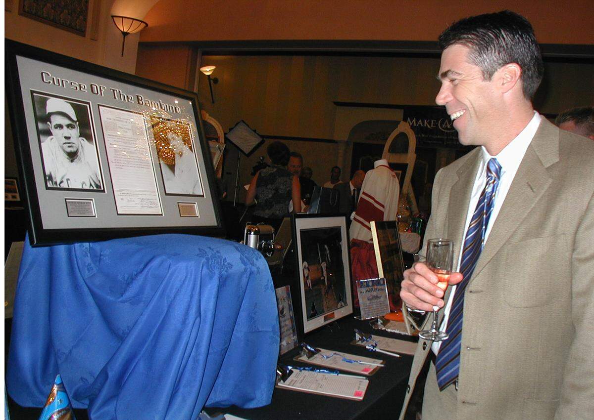 3/15/04 -- YVONNE CAREY/for The Herald -- Davie -- ESPN TV and radio sportscaster Chris Fowler CQ, host of College Gameday, plays his hand at bidding on the authentic, original 1919 contract that traded George Herman Ruth, otherwise known as “The Babe,” for a mere $25,000., from the Boston Red Sox to the New York Yankees, after the Sox won the series, in 1918. The staring bid was $450 and Fowler planned to get it at any cost, benefitting the Make-A-Wish Foundation at their 11th Annual 2004 Sports Banquet &Auction at the Signature Grand in Davie, last Monday.