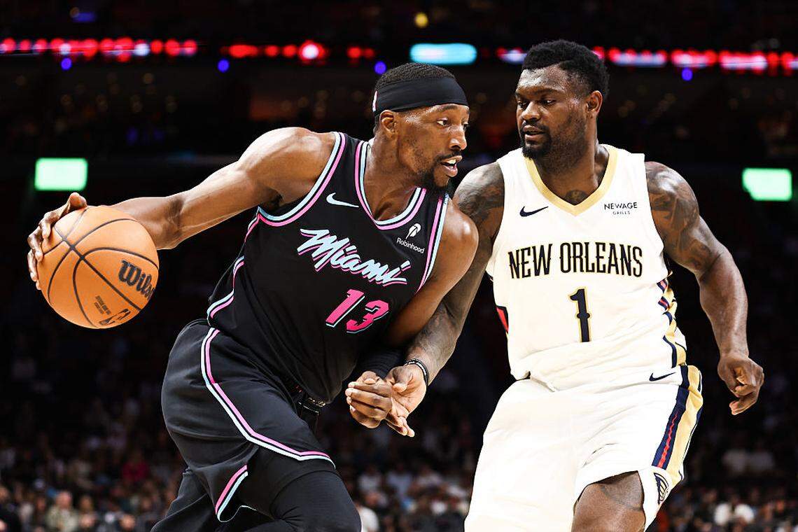 Bam Adebayo #13 of the Miami Heat drives against Zion Williamson #1 of the New Orleans Pelicans during the third quarter at Kaseya Center on January 04, 2026 in Miami.