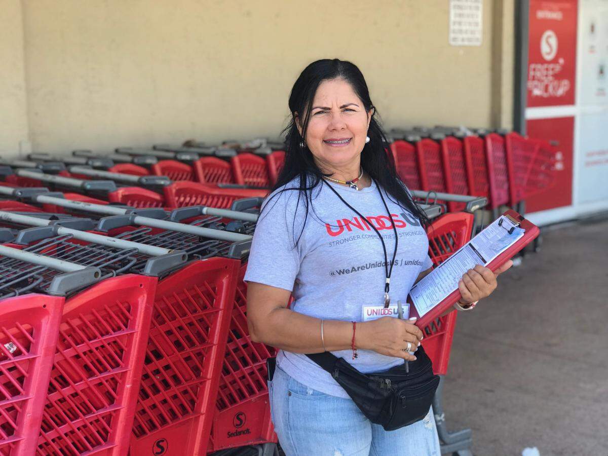 Lisbeth Hernandez, a canvasser for UnidosUS, registers Hispanic voters in front of a Sedano’s supermarket in Miami on Tuesday, Jan. 14, 2020.