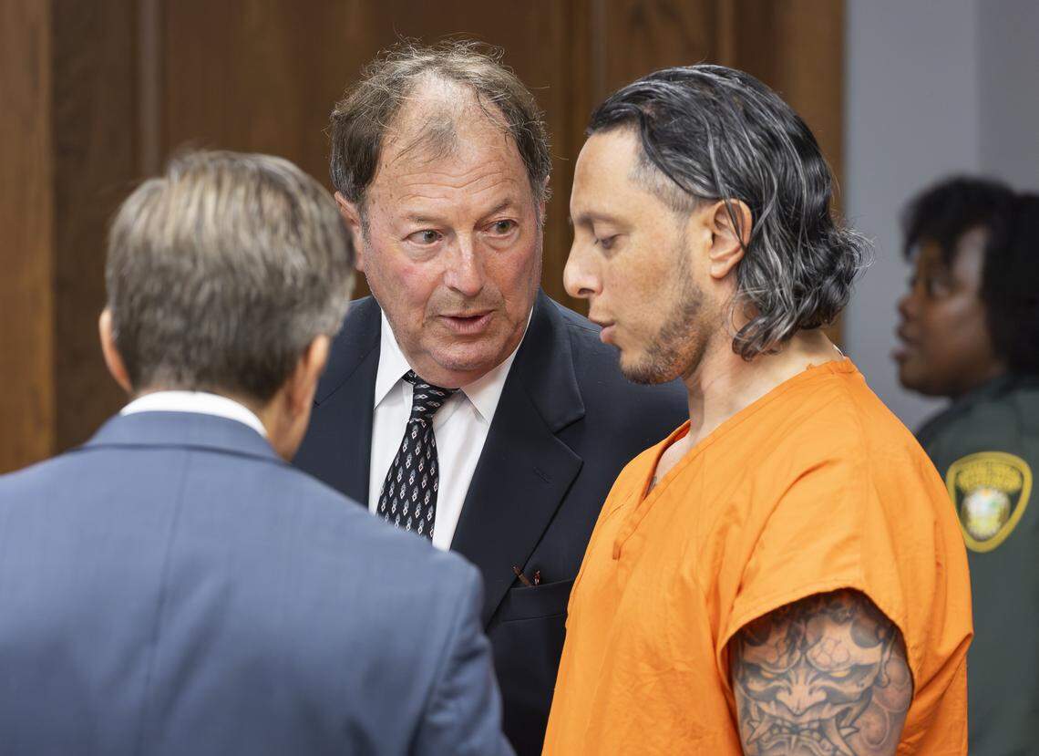 Oscar Olea, right, a former Key Biscayne gymnastics coach who allegedly sexually abused his students, talks with his attorneys Charlton Stoner, center, and Matthew Ladd, left, at the Richard E. Gerstein Justice Building on Thursday, Aug. 14, 2025, in Miami, Fla. Olea was seen at the courthouse after a plea agreement in his case was announced.