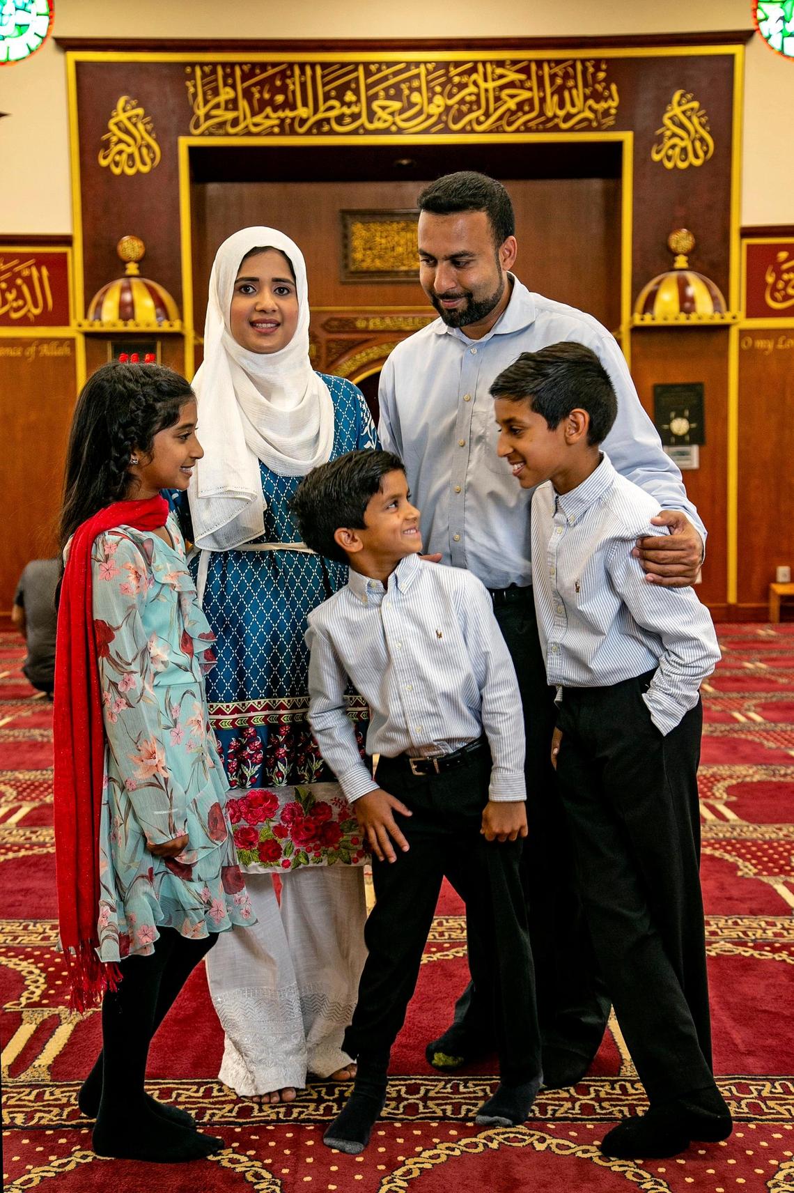 Tehsin Siddiqui, back left, and Azhar Dalal, with their children, from left, Noor Dalal, 9, Hamza Dalal, 7, and Ameen Dalal, 11, at the Islamic Center of Greater Miami in Miami Gardens on Friday.
