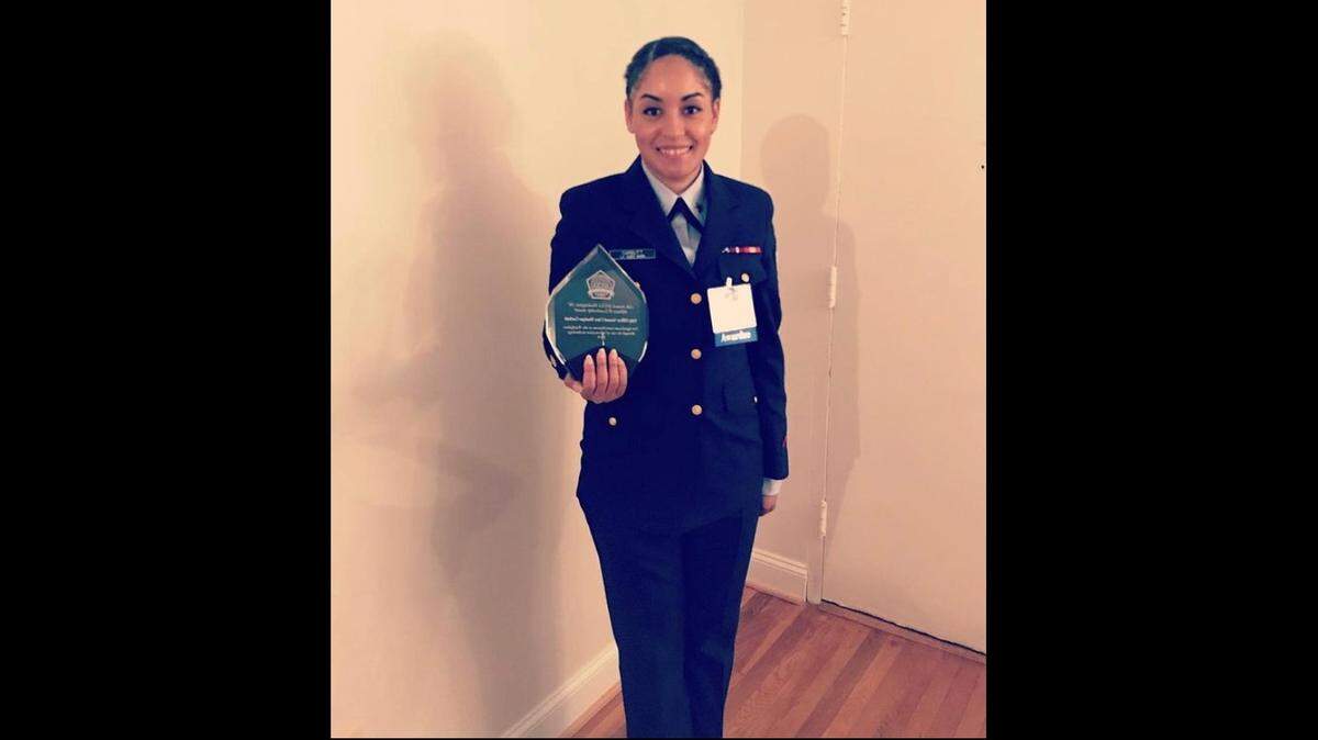 This photo shows Monique Garbutt in 2019 posing with a military IT award she had won. Months later she exited the Coast Guard, unhappy with how the service handled an assault against her and feeling that she had suffered retaliation.