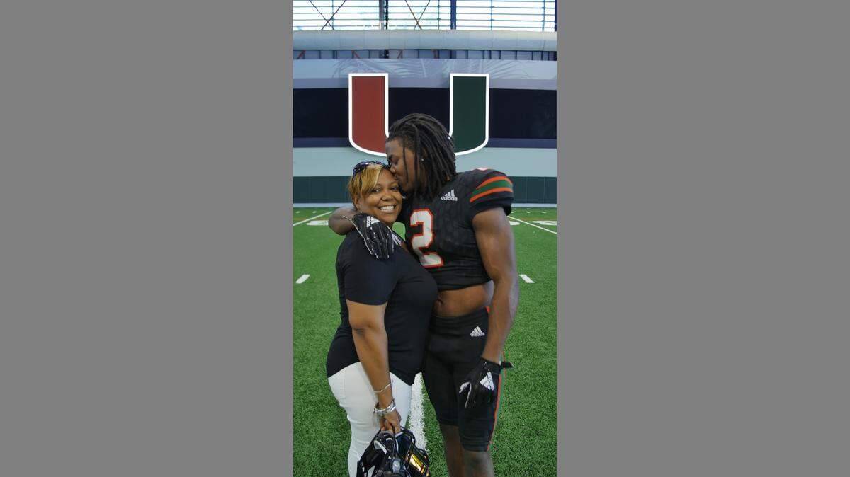 UM receiver K.J. Osborn, a graduate transfer and Biletnikoff Award candidate, gave his mother Valerie a smooch when she visited the campus in January 2019.