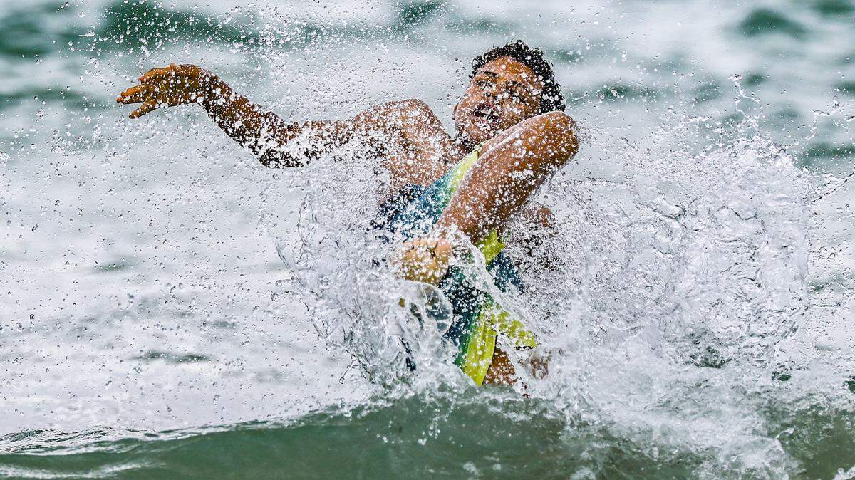 Diego Castro, 11, vacationing from Spain, jumps into a wave crashing onshore on Tuesday, April 7, 2026, near South Pointe Park in Miami Beach, Florida.