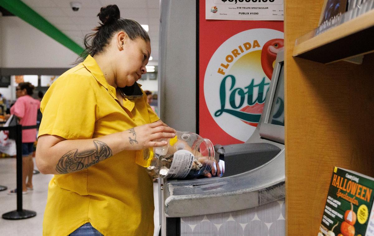 Johanna Villafranca pours $171 worth of coins into the coin counter at a Publix supermarket on Thursday, Oct. 3, 2024, in Miami. With increased costs in Miami, some people are having trouble buying groceries and paying rent. Villafranca has six kids, and her car was flooded recently. She has a $1,200 payment that she can’t pay.