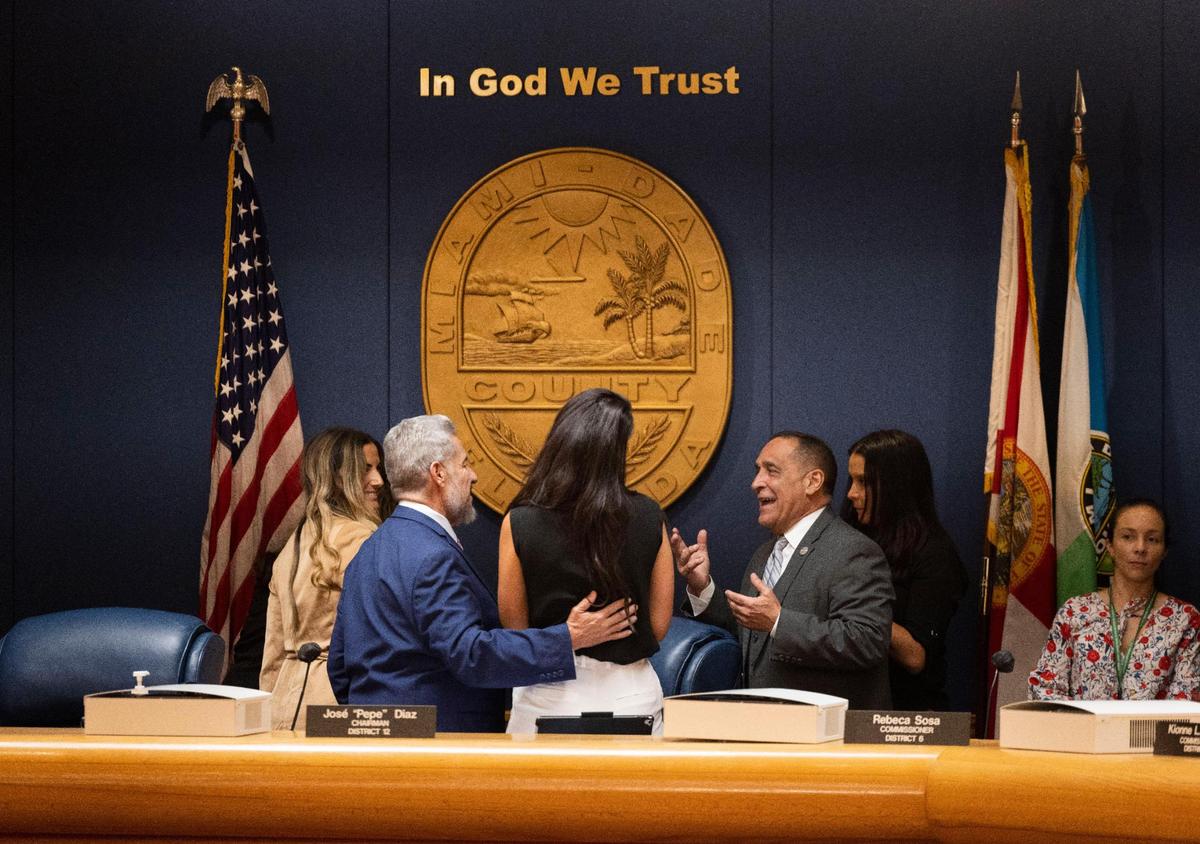 Commissioner Joe Martinez, right, talks to Commissioner Jose Diaz and others before the first Miami-Dade County budget hearing on Thursday, Sept. 8, 2022, at the Stephen P. Clark Government Center in Downtown Miami.