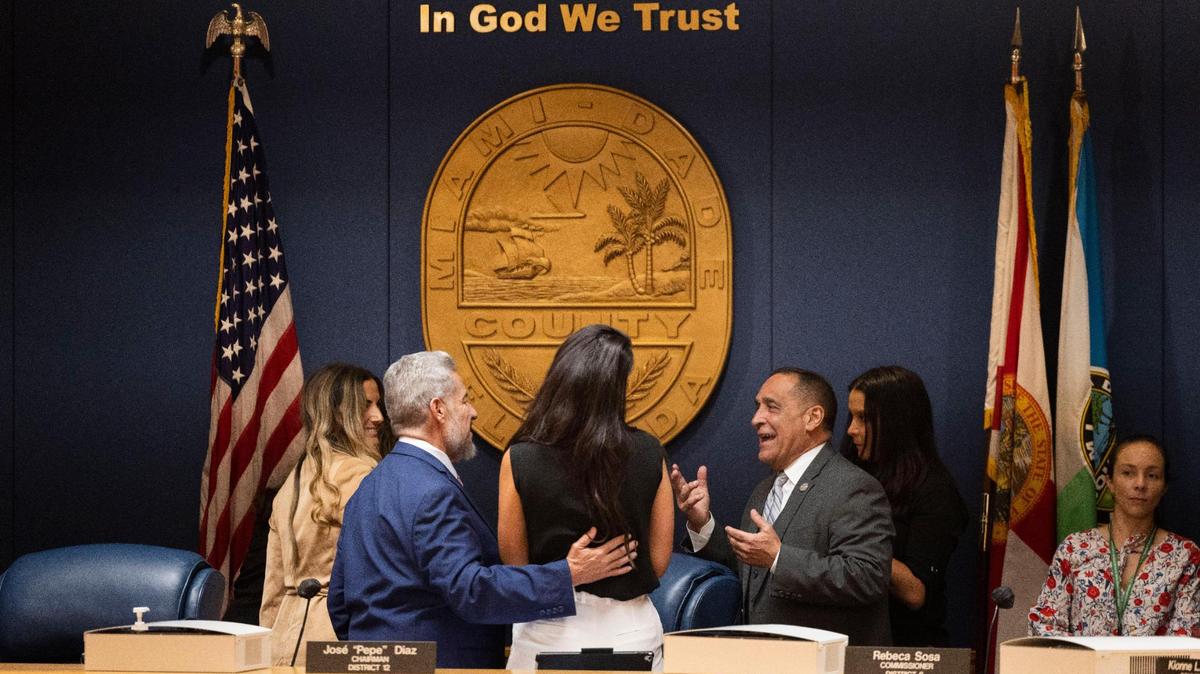 On Sept. 8, Commissioner Joe Martinez, right, talks to Commissioner Jose “Pepe” Diaz, left, and others before Miami-Dade County’s first 2023 budget hearing. A plan to pay former commissioners $25,000 a year to act as “County Ambassadors” faces a final vote after the second hearing on Sept. 20.
