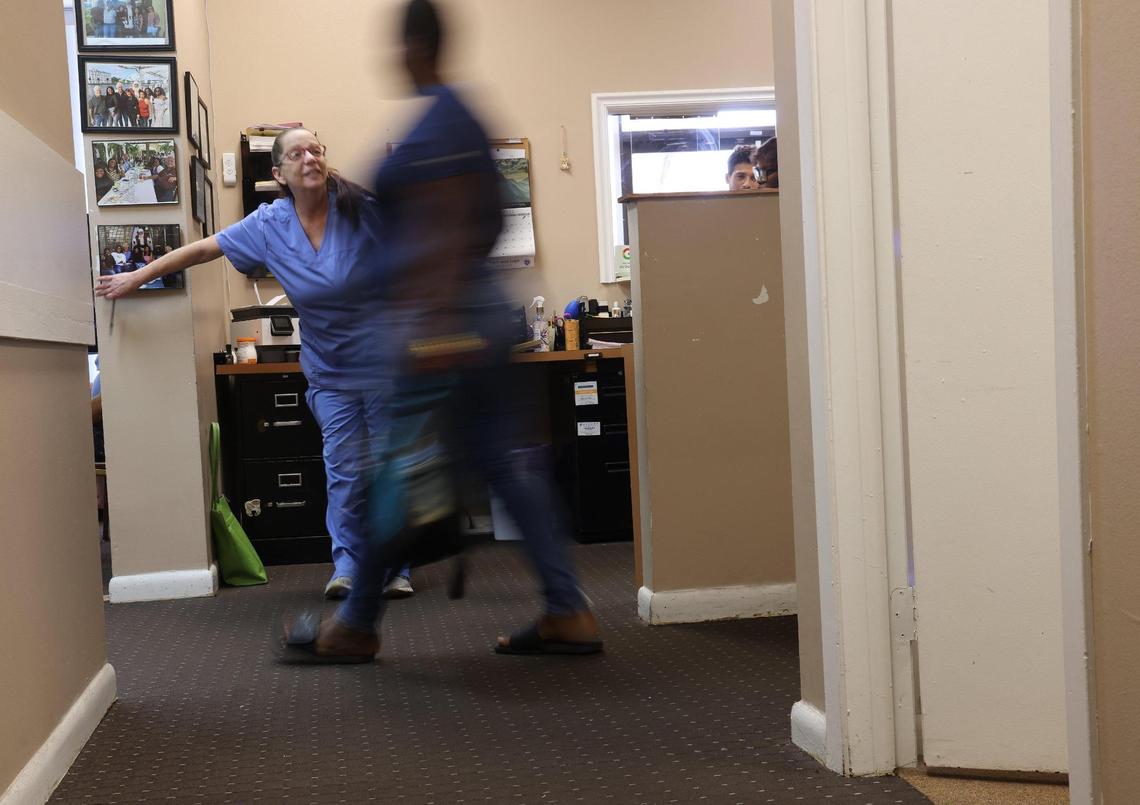 Sherri Loss, an LPN who came out of retirement during the pandemic to work at the East Cypress Women’s Center, guides patients during a busy morning at the clinic on Monday, April 24, 2023. Since June 2022, when Roe v. Wade was overturned, there has been a steady stream of women coming to the clinic to access abortion services.