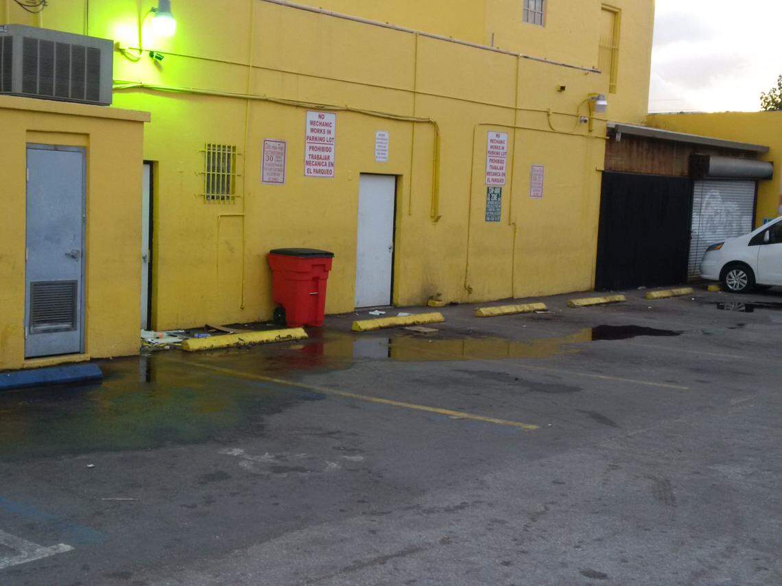 An arrest report says the surveillance camera just below the light on this building’s rear wall caught the carjacking and murder of Danial “Danny” Touhy by Christopher Bryant.