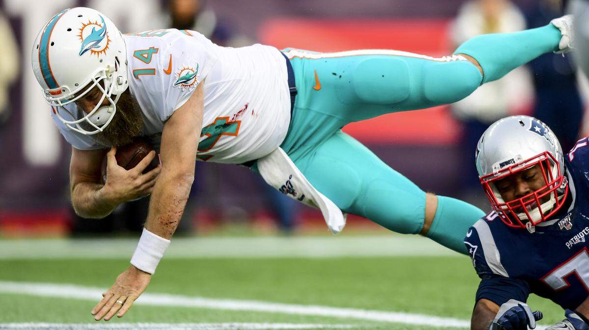 Ryan Fitzpatrick of the Miami Dolphins carries the ball for a touchdown during the third quarter of game against the New England Patriots at Gillette Stadium on December 29, 2019 in Foxborough, Massachusetts.