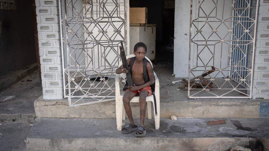 A nine-year-old boy who leads a gang of four or five other boys holds a shotgun. The neighborhood where he was photographed, Solino, had recently been invaded by larger armed groups, upsetting an island of calm in a capital city largely controlled by gangs.