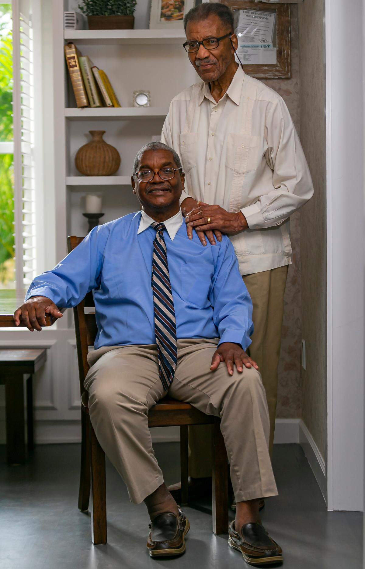George Simpson, left, and his father, Dr. George Simpson, are pictured inside the historic 1897 E.W.F. Stirrup House, which they restored with the help of development partners. The partners have opened the house as a bed-and-breakfast lodging, and are seeking a rezoning for lots they own across the street to build a companion Bahamian-style inn.