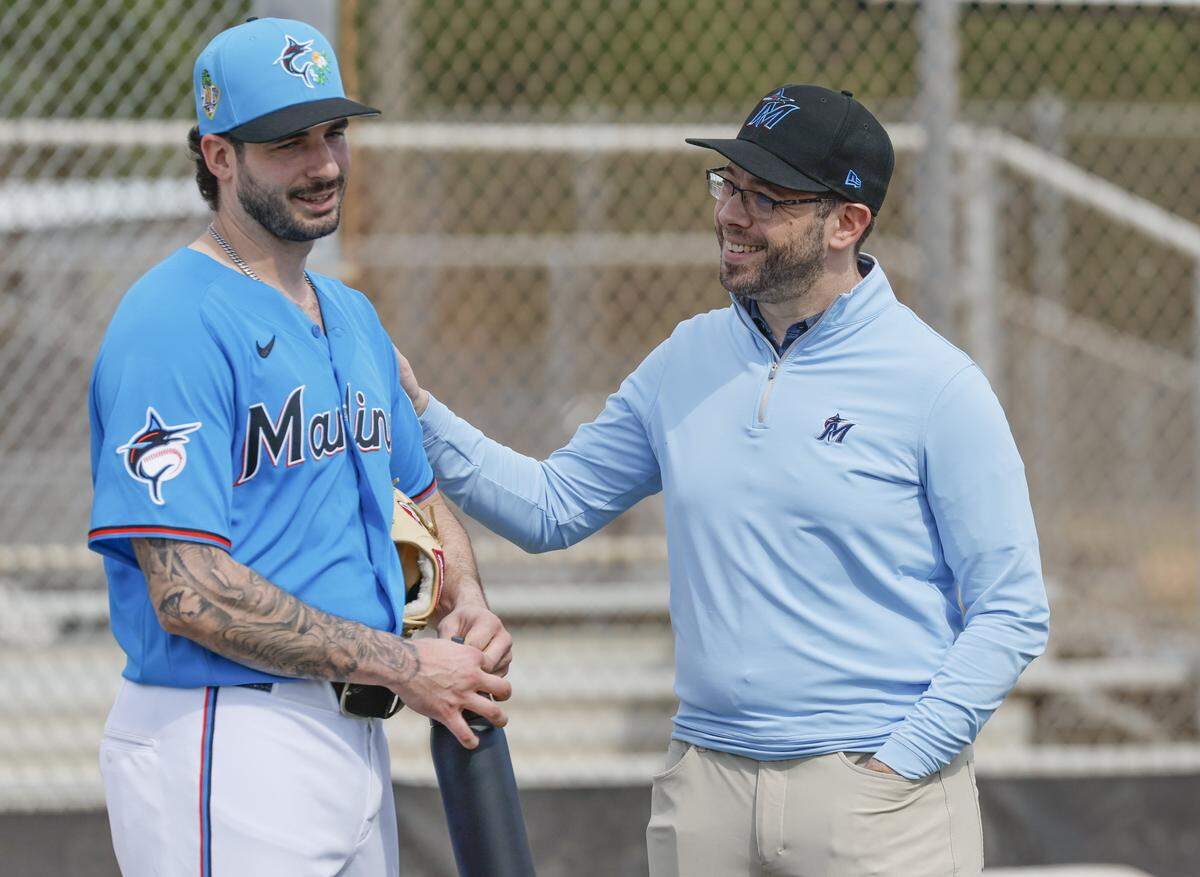 Miami Marlins President of Baseball Operations Peter Bendix greets pitcher Andrew Nardi (43) during first day of Miami Marlins spring training at Roger Dean Chevrolet Stadium in Jupiter, Florida on Wednesday, February 11, 2026