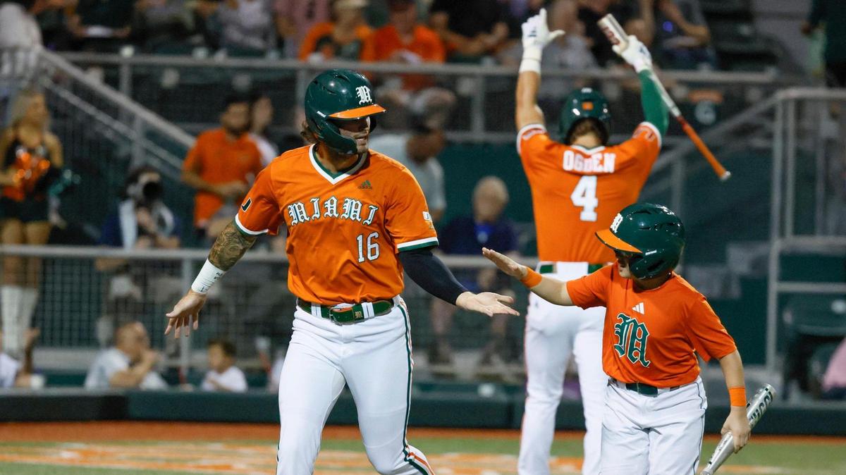 Miami Hurricanes outfielder Bobby Marsh (16) celebrates with the ball boy after crossing home plate to score against Niagara University in the second inning at Alex Rodriguez Park at Mark Light Field on the University of Miami Campus in Coral Gables, Florida on Friday, February 14, 2025.