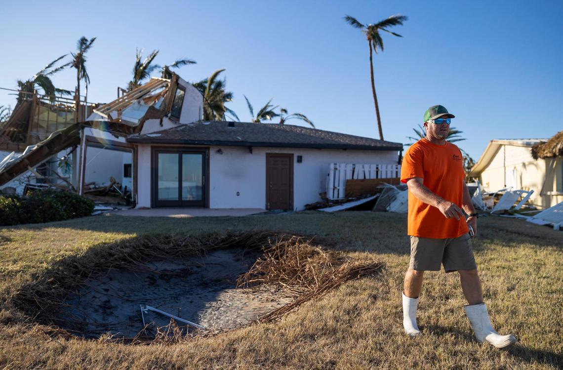 Craig Stevens surveys a home’s damage on the southern tip of St. James City on Friday, Sept. 30, 2022, in Pine Island, Florida. Hurricane Ian made landfall on the coast of Southwest Florida as a Category 4 storm Wednesday afternoon leaving areas affected with flooded streets, downed trees and scattered debris.