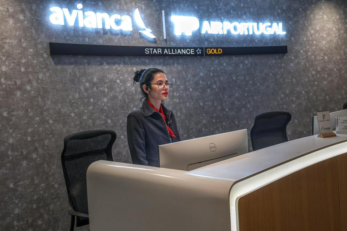 A host is ready to greet travelers at the Avianca travel lounge at Miami International Airport.