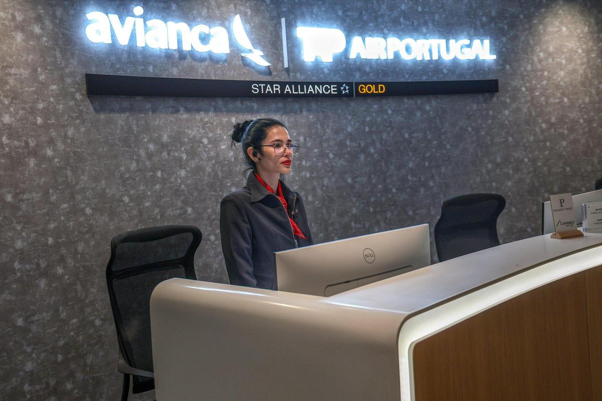 A lounge host remains ready to greet travelers at the Avianca travel lounge  at the J Terminal at the Miami airport on March 19, 2025.